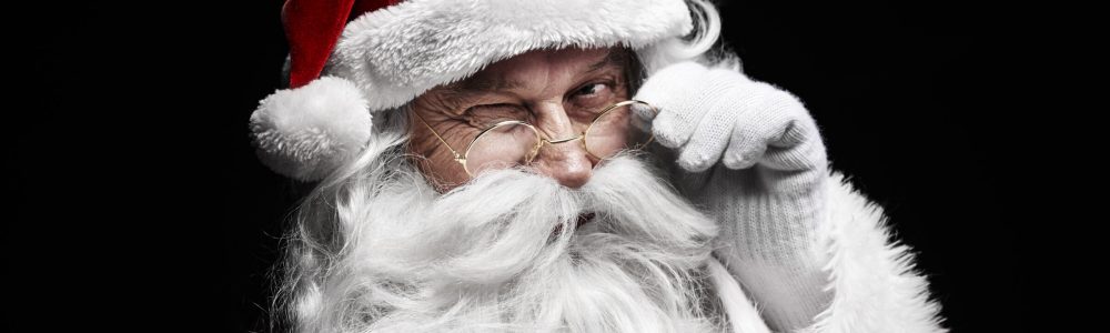 Man in santa claus costume winking